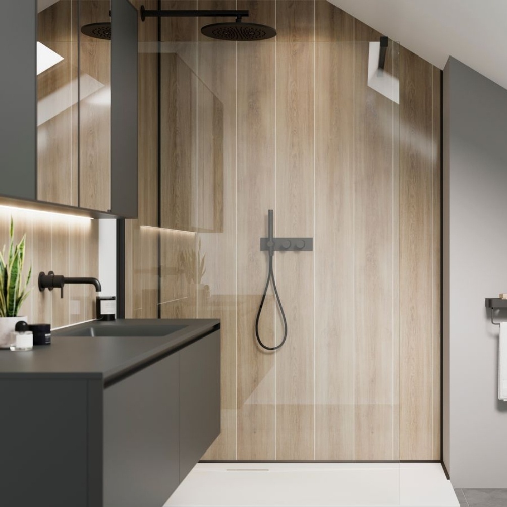 Lifestyle image of the Showerwall Laminate Katla Natural 2400mm x 600mm Plank Tile Effect Wall Panel - SWT12 installed within a walk-in shower enclosure with black concealed shower system & rainfall shower head